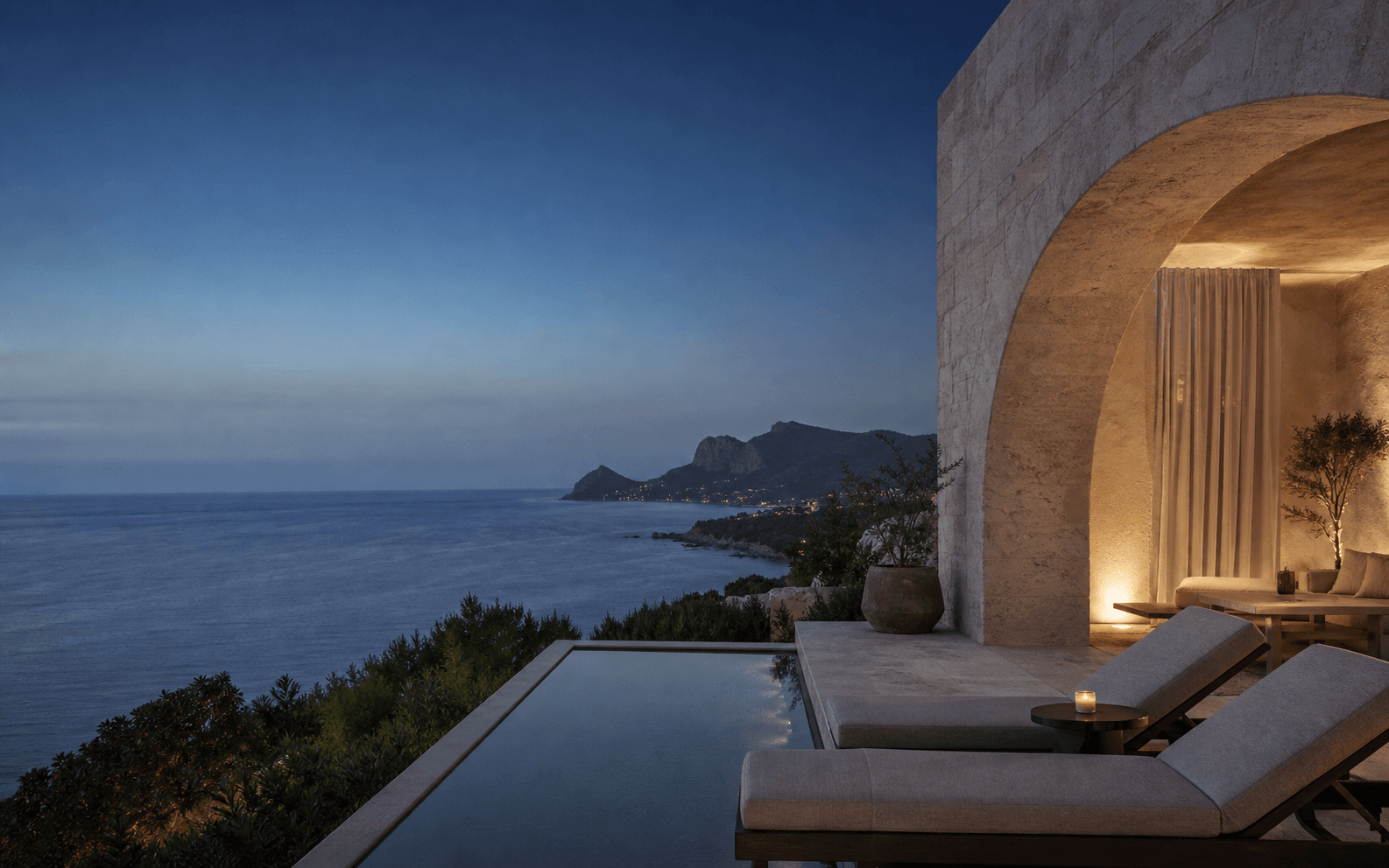 A quiet coastal hotel terrace overlooking the sea at dusk